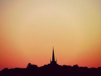 Silhouette temple against sky during sunset