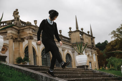 Man standing in front of historical building