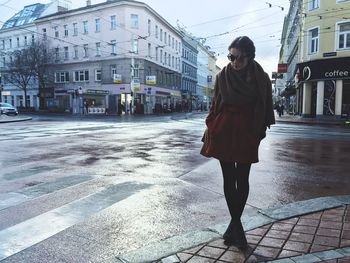 Woman standing on city street