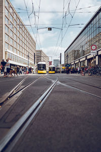 Vehicles on road amidst buildings in city