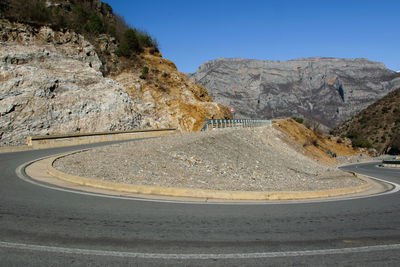 Scenic view of mountain road against clear sky