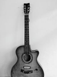 High angle view of guitar against wall