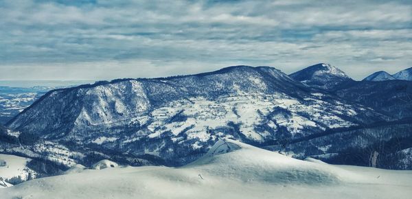 Scenic view of snowcapped mountains against sky