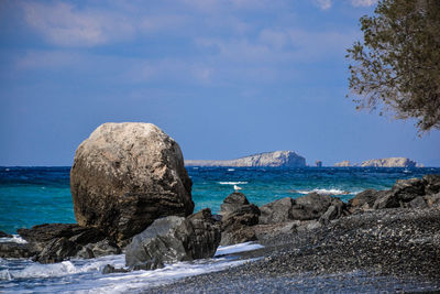 Rocks on beach against sky