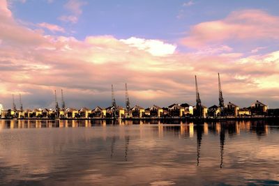 View of river against cloudy sky at sunset