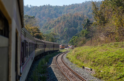 View from the rear of a train that leaves from the small station on the highest mountain range