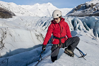 Woman climbing on the fjallsjökull glacier in iceland