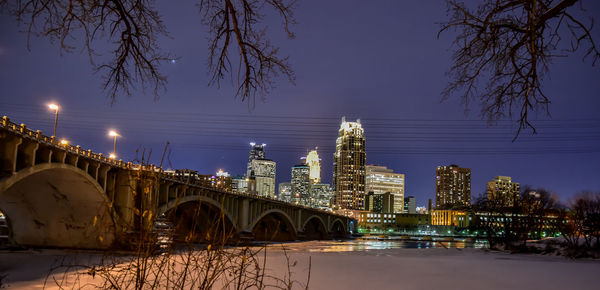 Robert street bridge over mississippi river by illuminated city at night