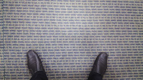 Low section of woman standing on tiled floor