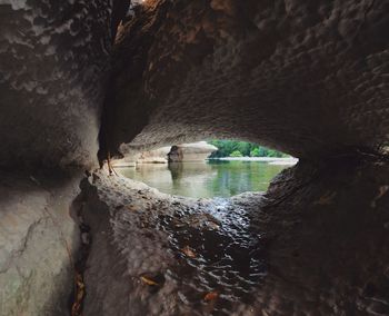 Scenic view of lake seen through cave