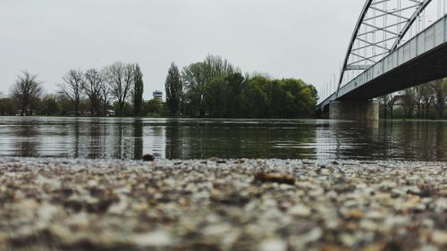 Surface level of bridge over river against sky