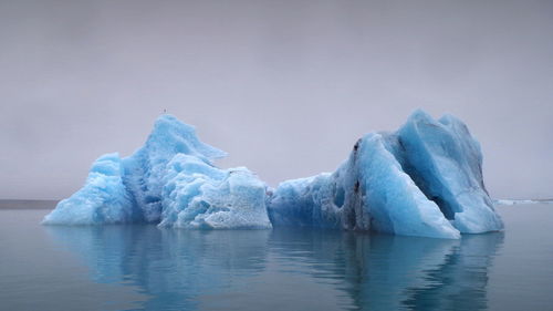 Scenic view of frozen lake against sky