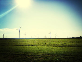 Wind turbines on grassy field