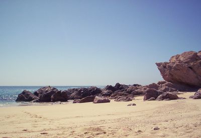 Scenic view of beach against clear sky