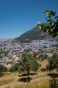 High angle view of townscape against clear blue sky