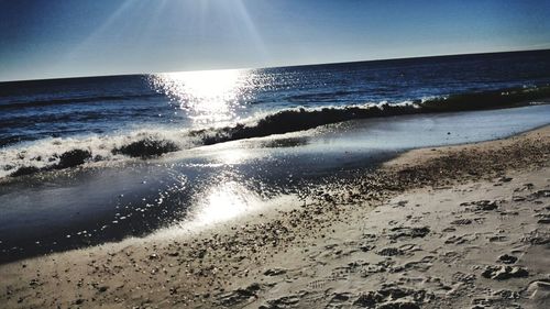 Scenic view of beach against clear sky