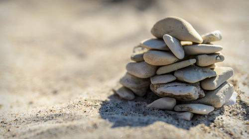 Close-up of stack of stones on sand