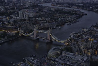 High angle view of illuminated tower bridge over thames river at dusk