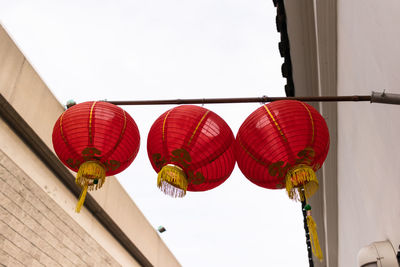 Low angle view of lanterns hanging against sky