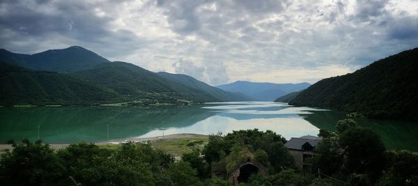 Scenic view of lake and mountains against sky