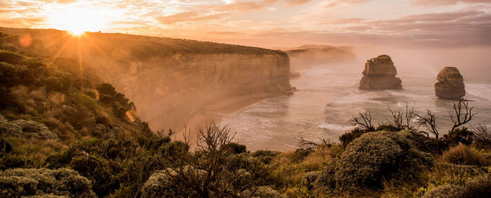 Scenic view of great ocean road during sunset