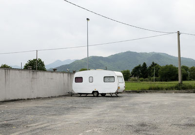 Motor home on road against cloudy sky