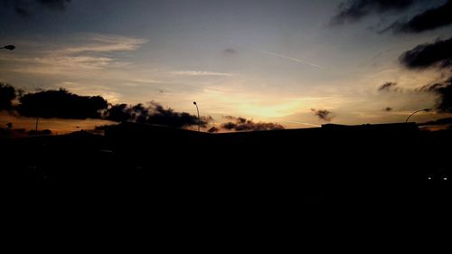 Silhouette buildings against sky during sunset