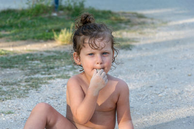 Portrait of shirtless boy on beach