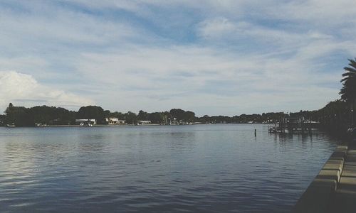 Scenic view of lake against cloudy sky