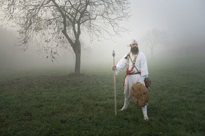 People on field during foggy weather