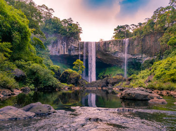 Scenic view of waterfall against rocks