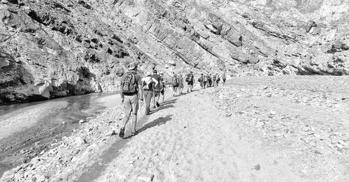 Rear view of people hiking on mountain 