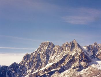 Scenic view of rocky mountains against sky on sunny day