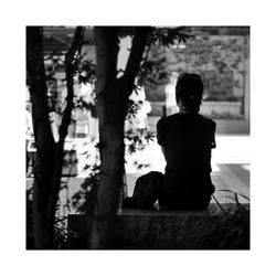 Woman sitting on tree stump