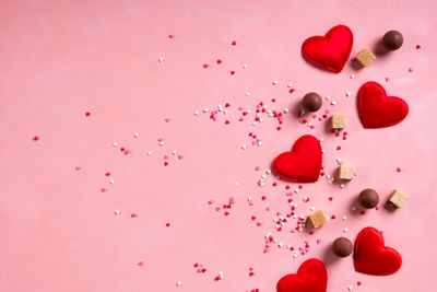 High angle view of pink berries against gray background