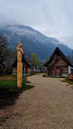 House on field against mountain