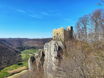 Built structure on land against blue sky