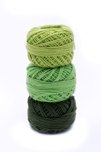 Stack of multi colored pencils against white background