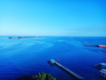 High angle view of sea against clear blue sky