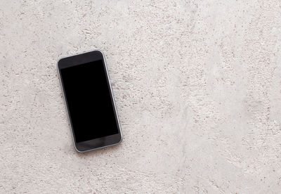 Close-up of smart phone on wall
