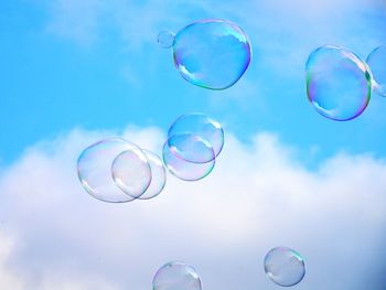 Low angle view of bubbles against sky