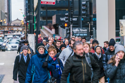 Group of people walking on city street