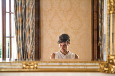 Portrait of young man sitting at home