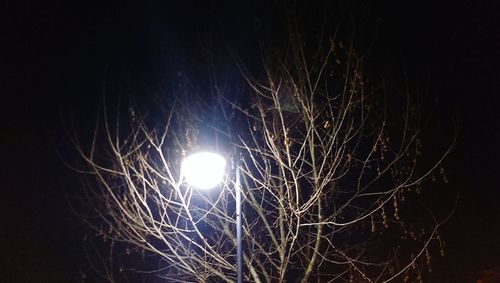 Low angle view of illuminated lights at night