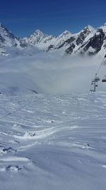 Scenic view of snow covered mountains against sky