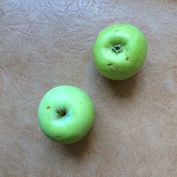 High angle view of apples on green table