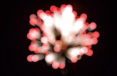 Close-up of illuminated over black background