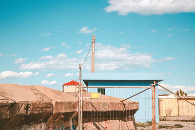 Cranes at construction site against sky