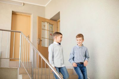 Boy standing on staircase in building