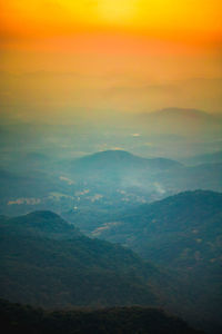 Scenic view of dramatic sky over landscape during sunset